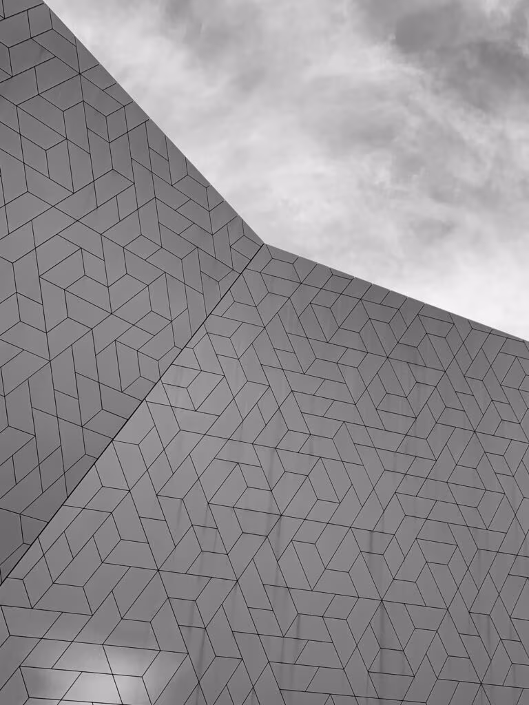 Fachada geométrica gris bajo un cielo nublado, imagen de los 1,6 millones de Países Bajos para la investigación psicodélica